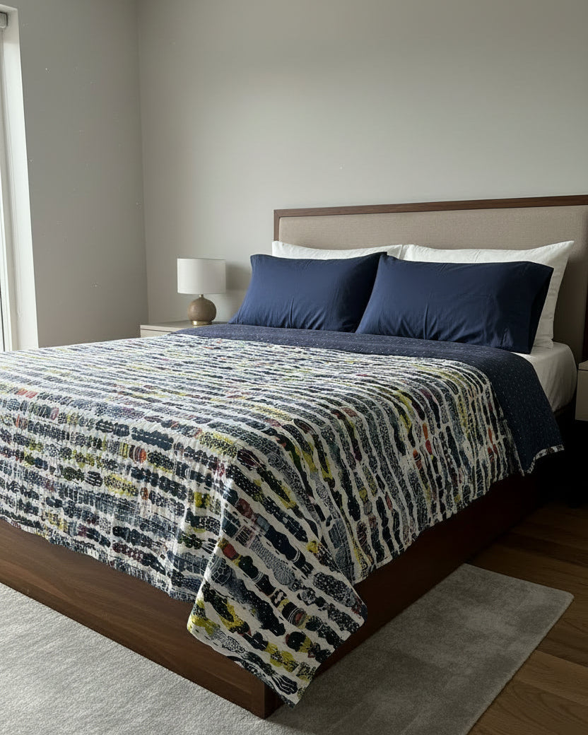 Abstract print handloom slub cotton king size bed cover featuring an artistic textured weave and handcrafted fringe tassels.