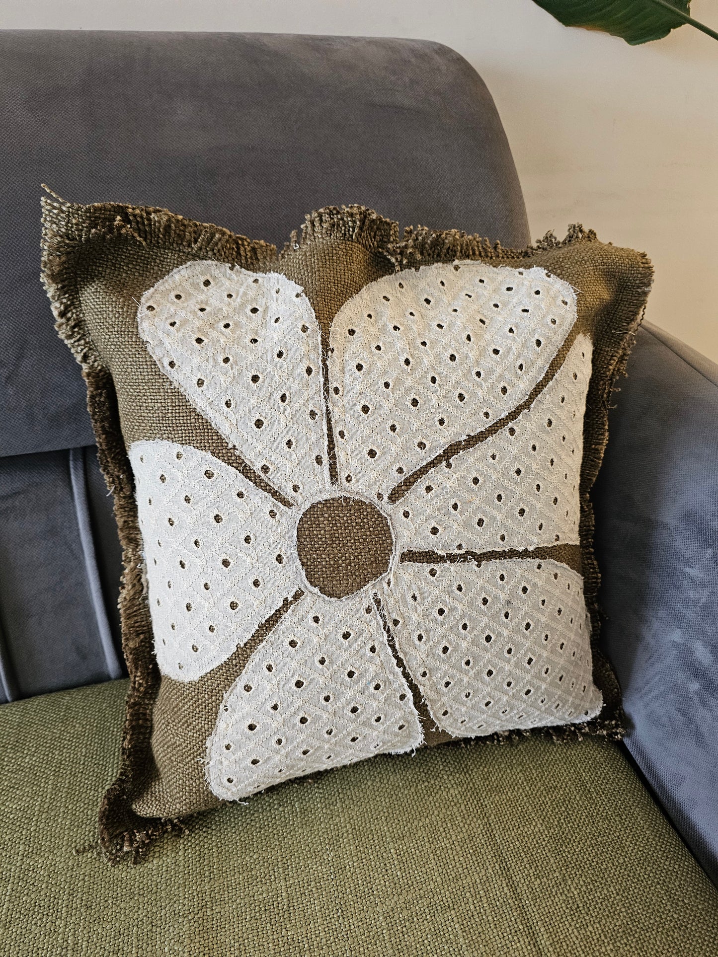 Decorative pillow with a floral pattern on a couch