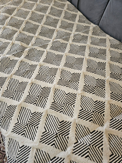 Close-up of a textured fabric with a geometric pattern on a gray surface