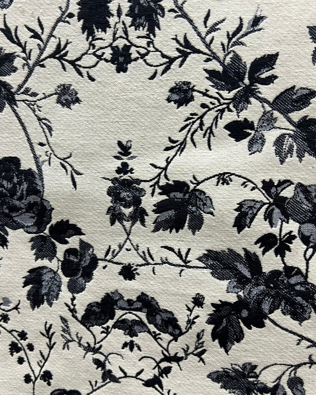 Black and white floral cotton jacquard table cover featuring a reversible monochrome woven pattern and decorative fringe tassels.