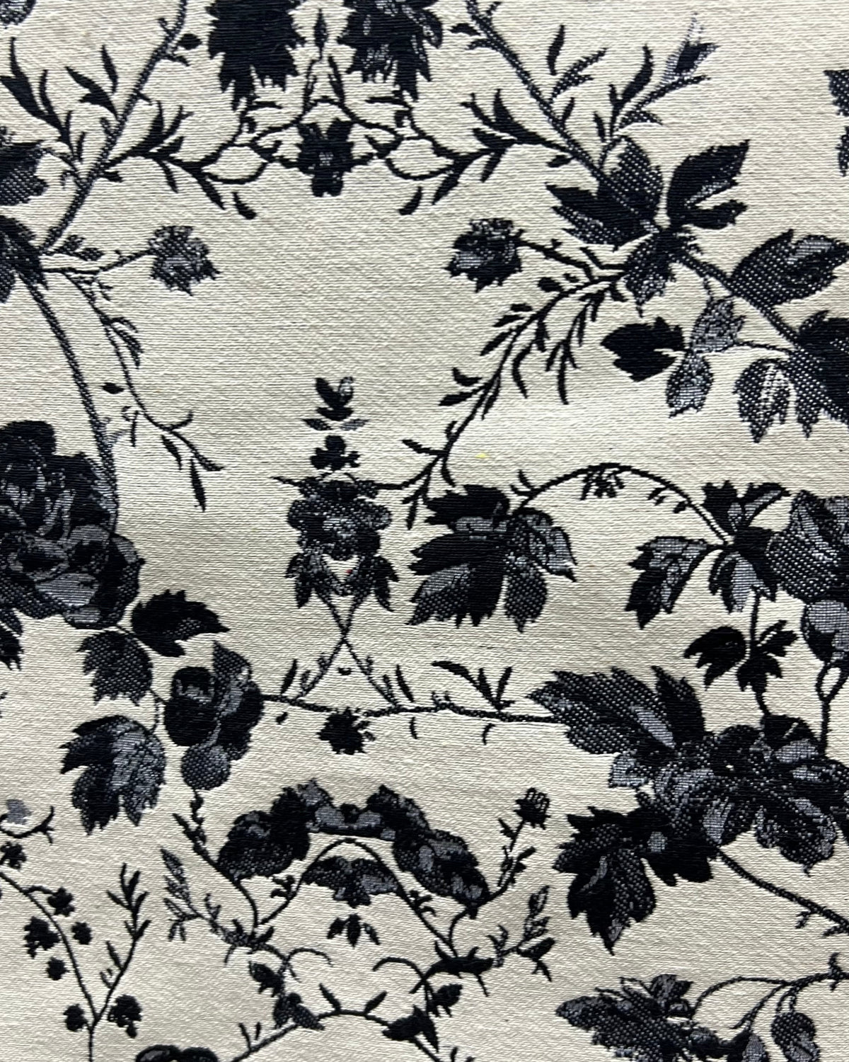 Black and white floral cotton jacquard table cover featuring a reversible monochrome woven pattern and decorative fringe tassels.