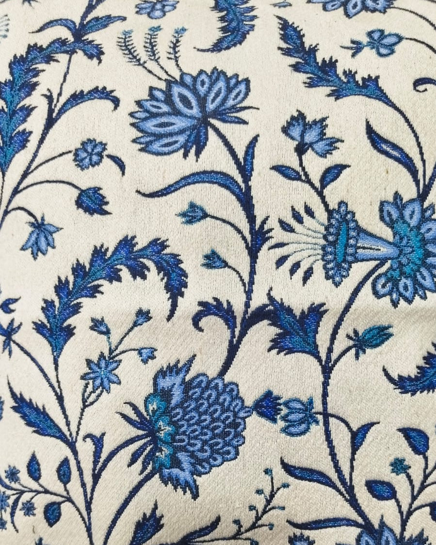 Cream cotton cushion cover featuring an intricate woven blue floral and botanical vine jacquard pattern.
