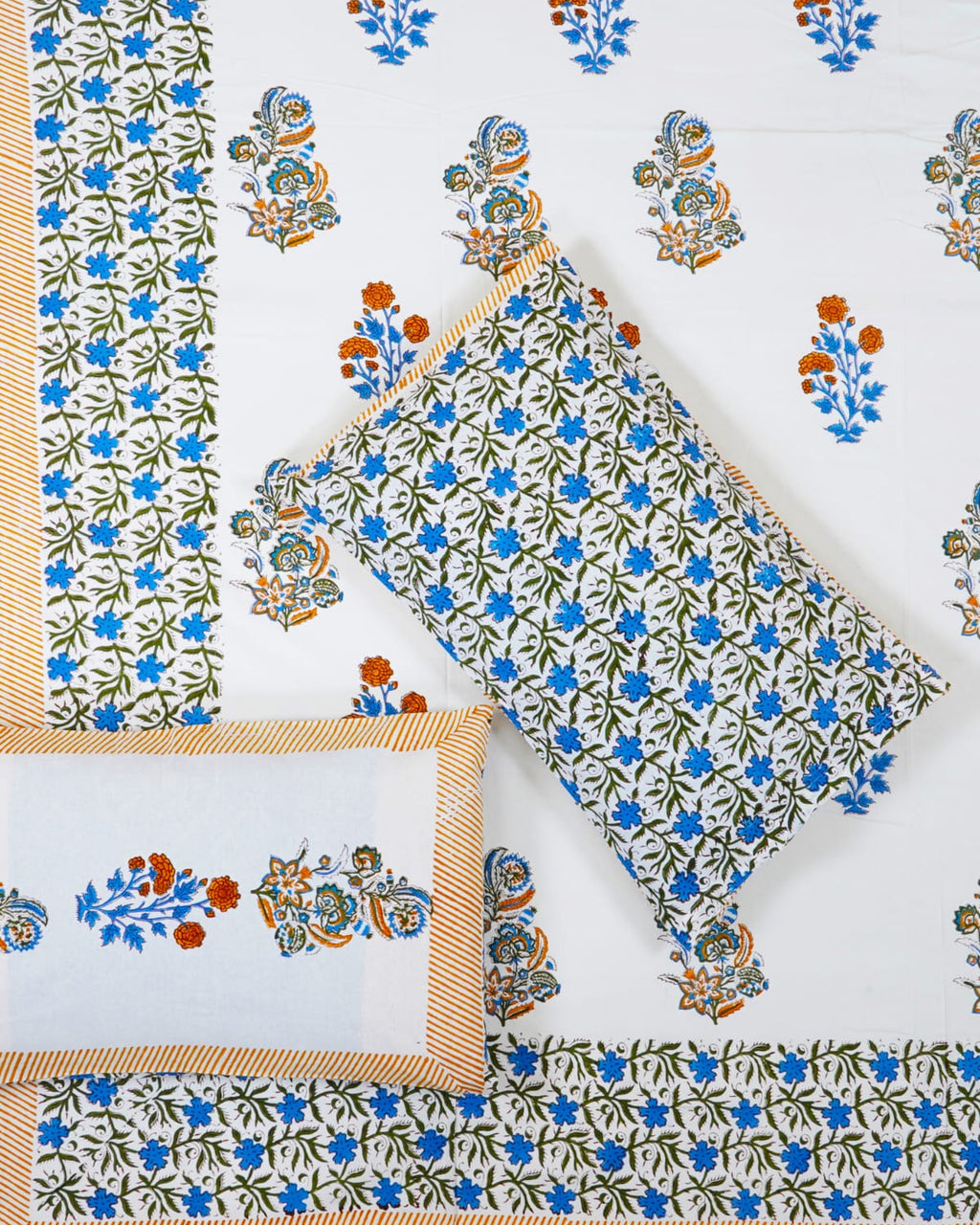 100x108 inch king size cotton bedsheet and matching striped pillow covers styled with a traditional blue floral butta and orange motif handblock print.