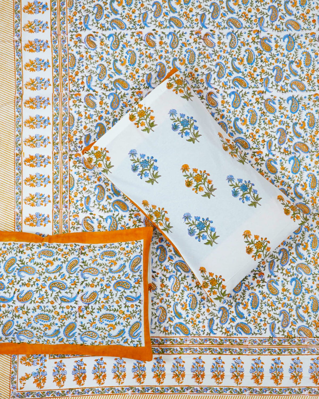 00x108 inch king size cotton bedsheet and matching solid orange-bordered pillow covers styled with a traditional blue and orange paisley handblock print.