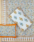 00x108 inch king size cotton bedsheet and matching solid orange-bordered pillow covers styled with a traditional blue and orange paisley handblock print.