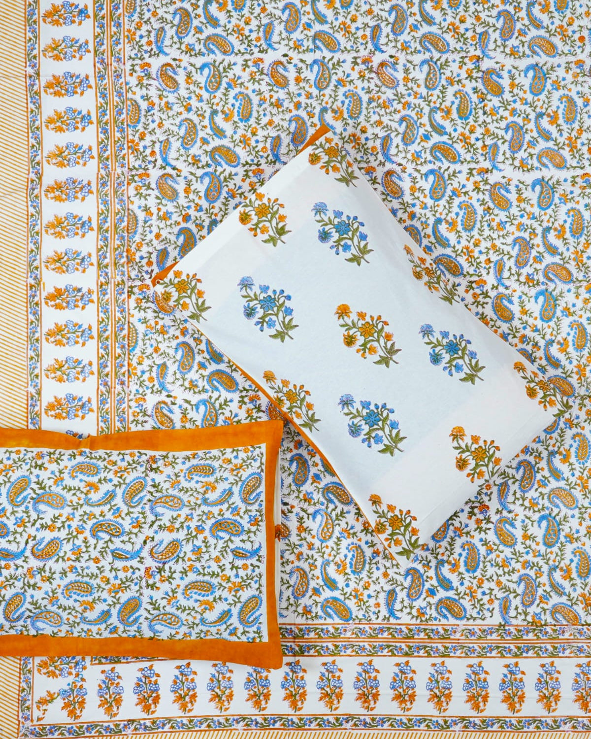 00x108 inch king size cotton bedsheet and matching solid orange-bordered pillow covers styled with a traditional blue and orange paisley handblock print.
