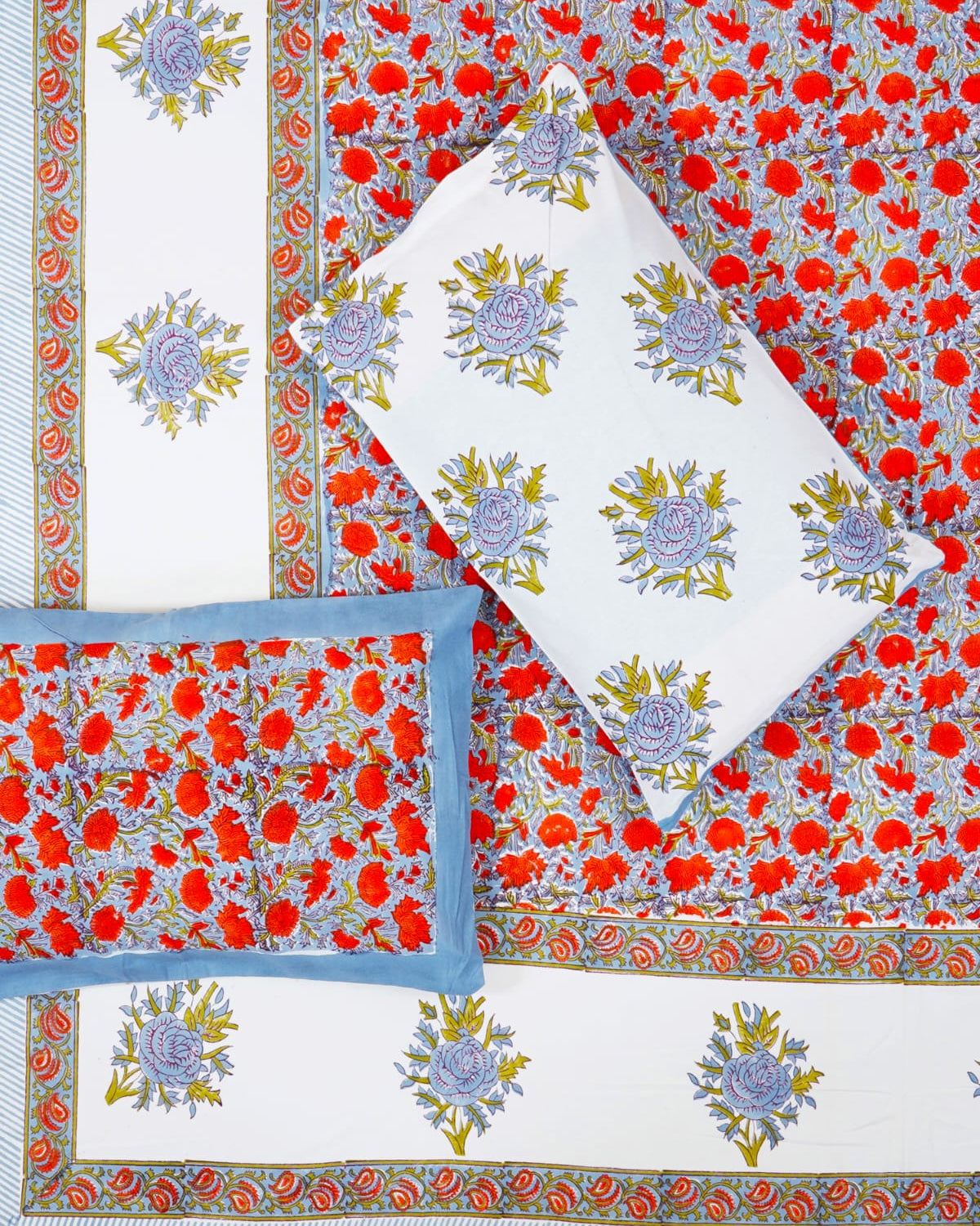 100x108 inch king size cotton bedsheet and matching pillow covers styled with a traditional blue and red-orange handblock floral print.