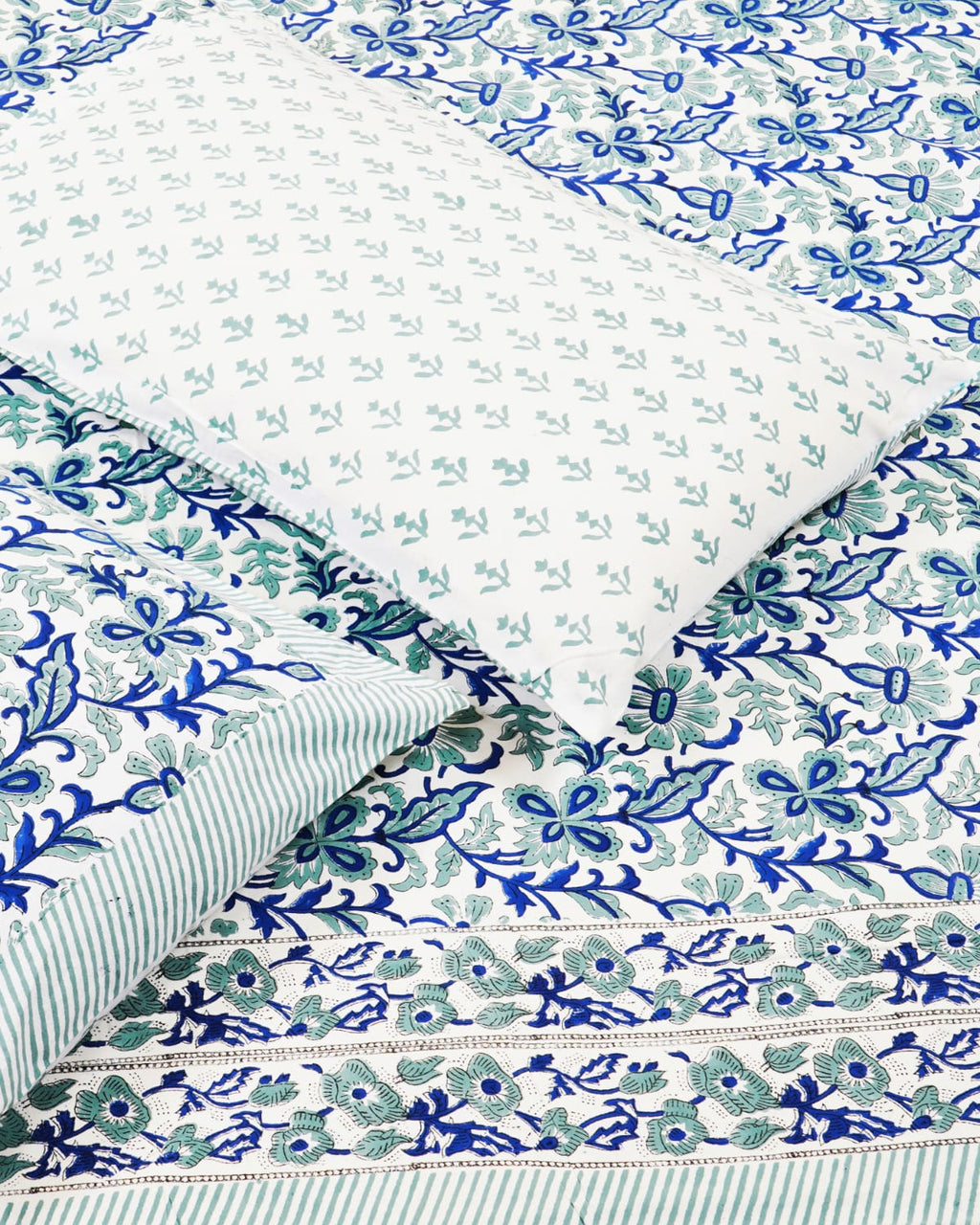 100x108 inch king size cotton bedsheet and matching striped pillow covers styled with a traditional blue and teal floral vine handblock print.