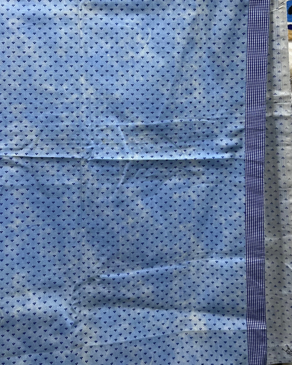Blue and white small-print cotton table cover featuring a delicate micro-pattern and a contrasting checkered border trim.