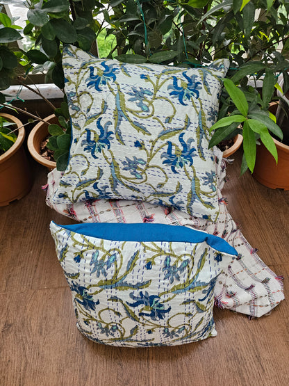 Decorative pillows with floral patterns on a wooden surface
