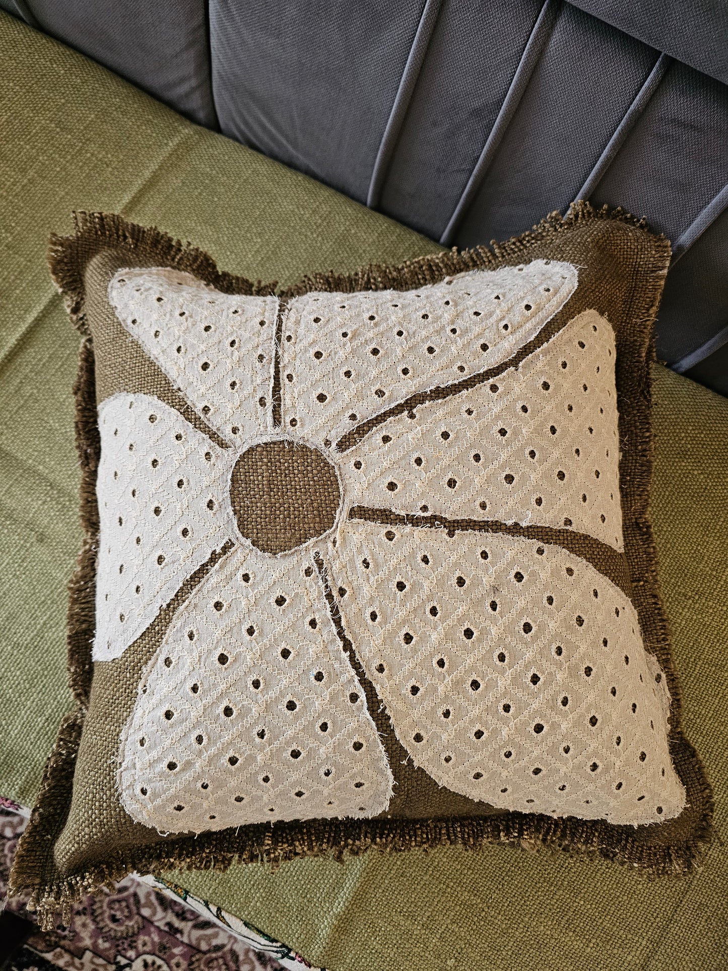 Decorative pillow with a unique pattern on a green surface
