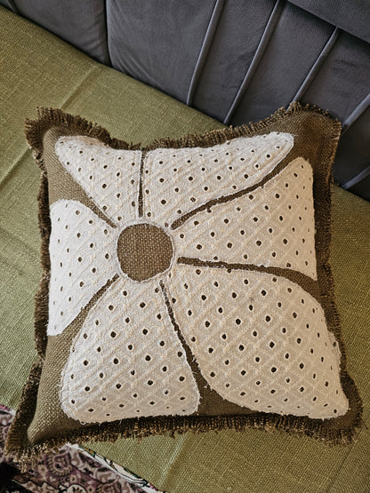 Decorative pillow with a unique pattern on a green surface
