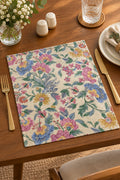 Botanical floral jacquard cotton placemat featuring a woven vintage garden print with pink, yellow, and blue flowers on a neutral base.