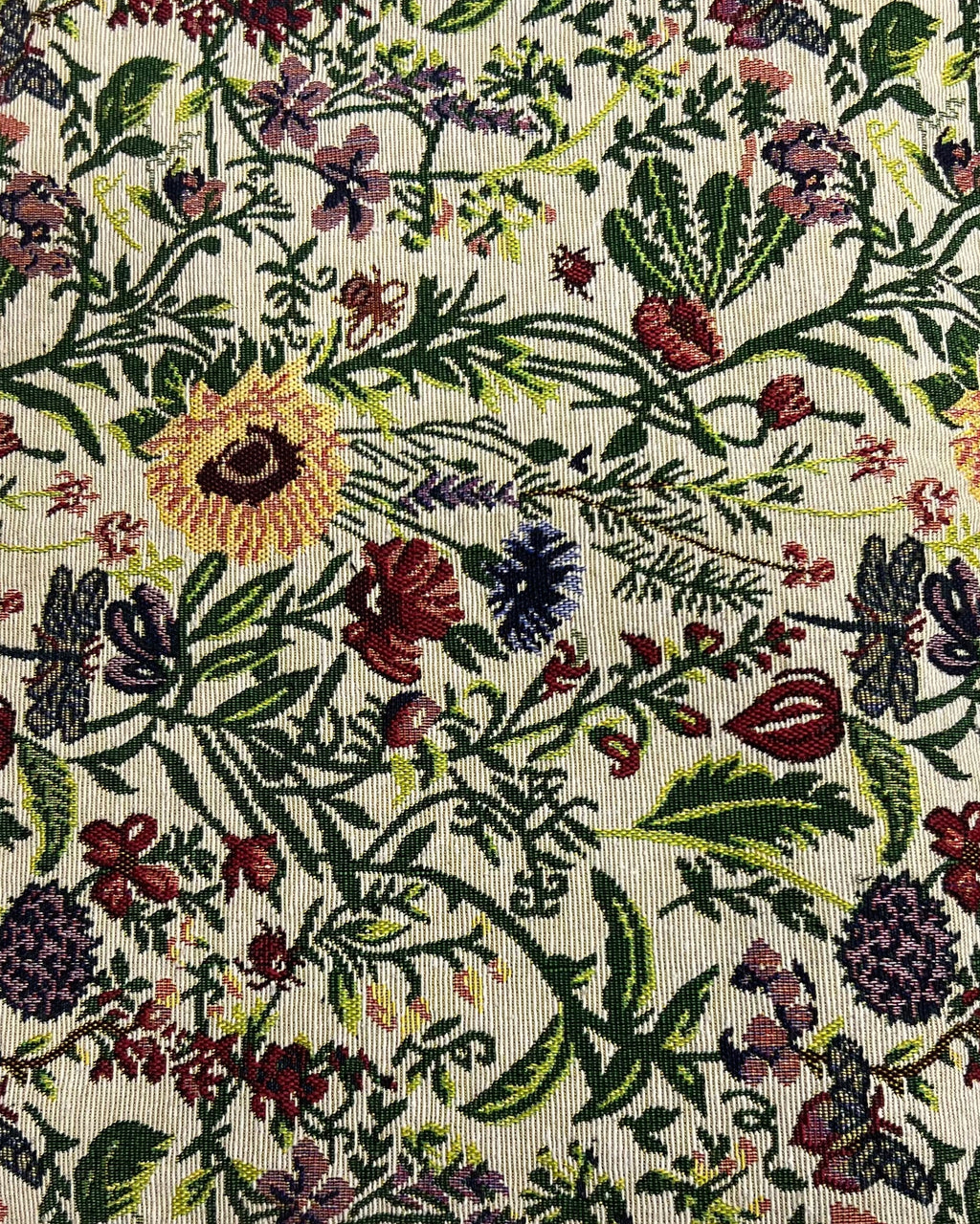 Botanical jacquard cotton placemat featuring a colorful woven floral garden pattern with vibrant blooms and green foliage.