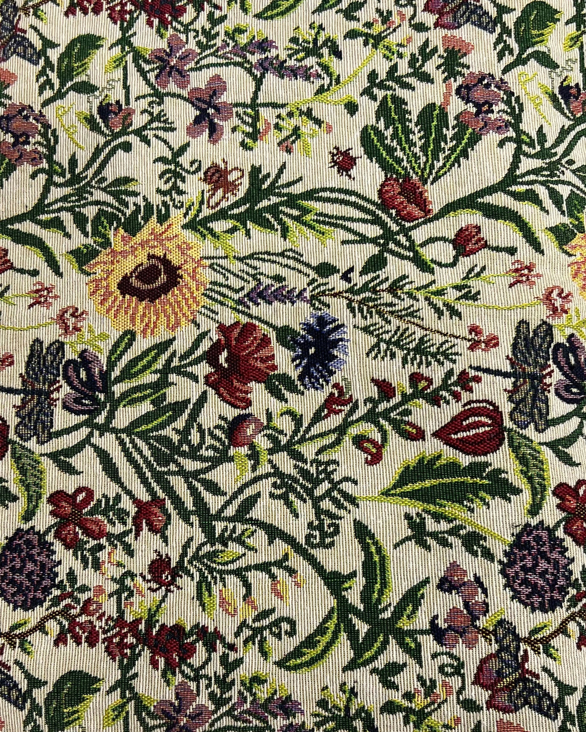 Botanical jacquard cotton placemat featuring a colorful woven floral garden pattern with vibrant blooms and green foliage.