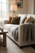 Charcoal grey and cream handwoven chunky woolen sofa throw blanket featuring a windowpane grid plaid weave and twisted fringe tassels.