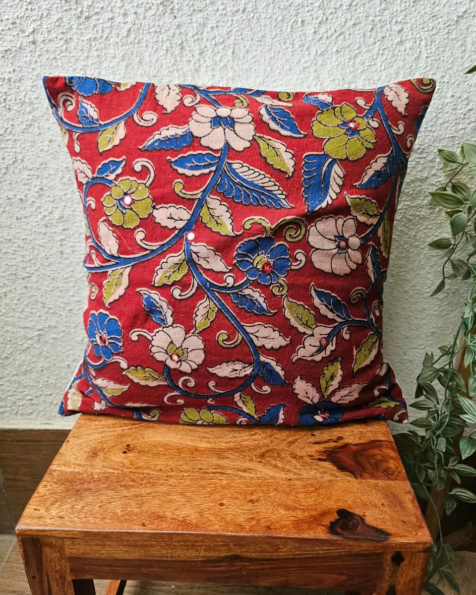 Crimson red cotton cushion cover featuring traditional blue and floral handblock vine prints with subtle accent embellishments.