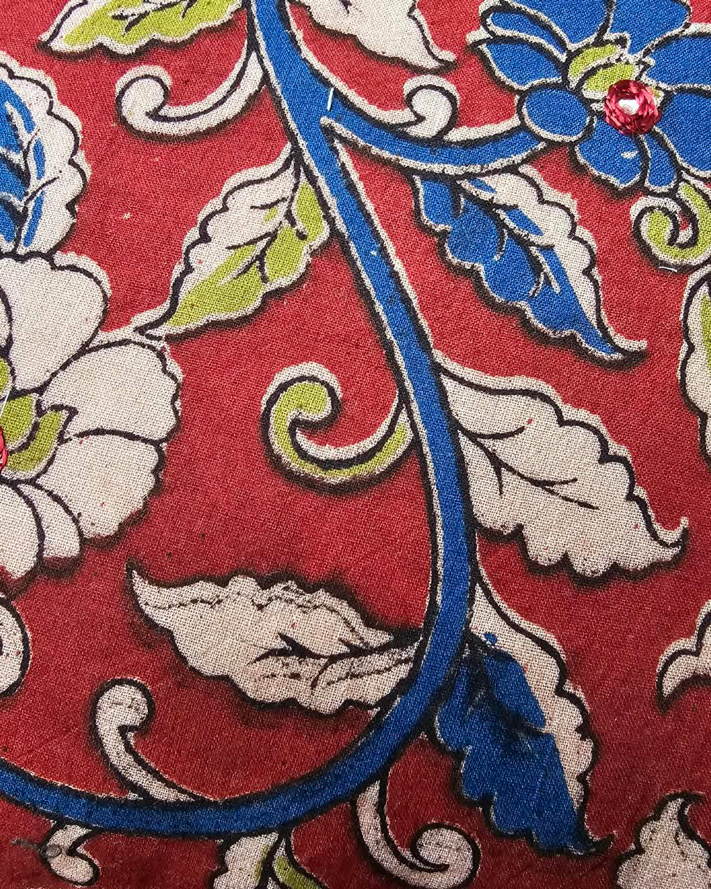 Crimson red cotton cushion cover featuring traditional blue and floral handblock vine prints with subtle accent embellishments.