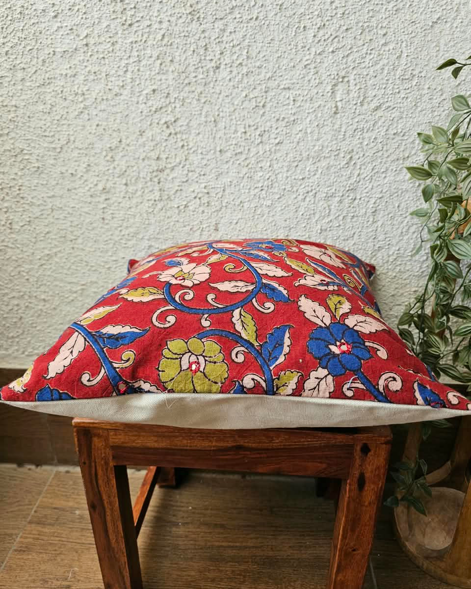 Crimson red cotton cushion cover featuring traditional blue and floral handblock vine prints with subtle accent embellishments.