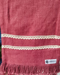 Dark pink jute-cotton handloom table runner featuring two parallel rows of off-white crochet lace trim and a matching self-fringed hem, with Vasaca brand labels.