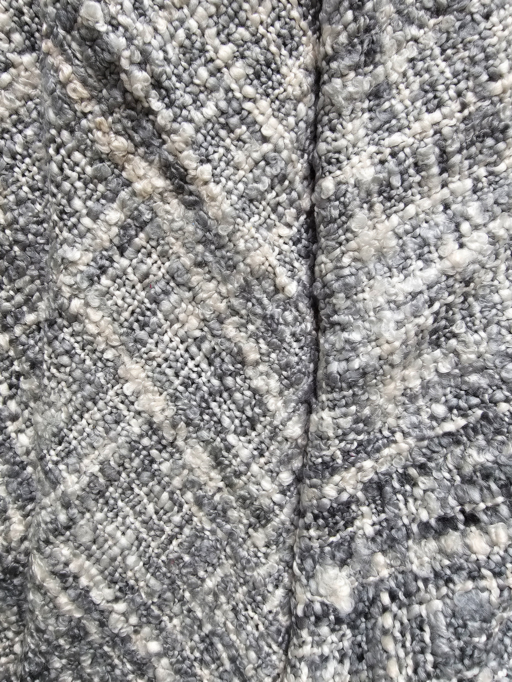 Close-up of textured stone surface with a crack running through it