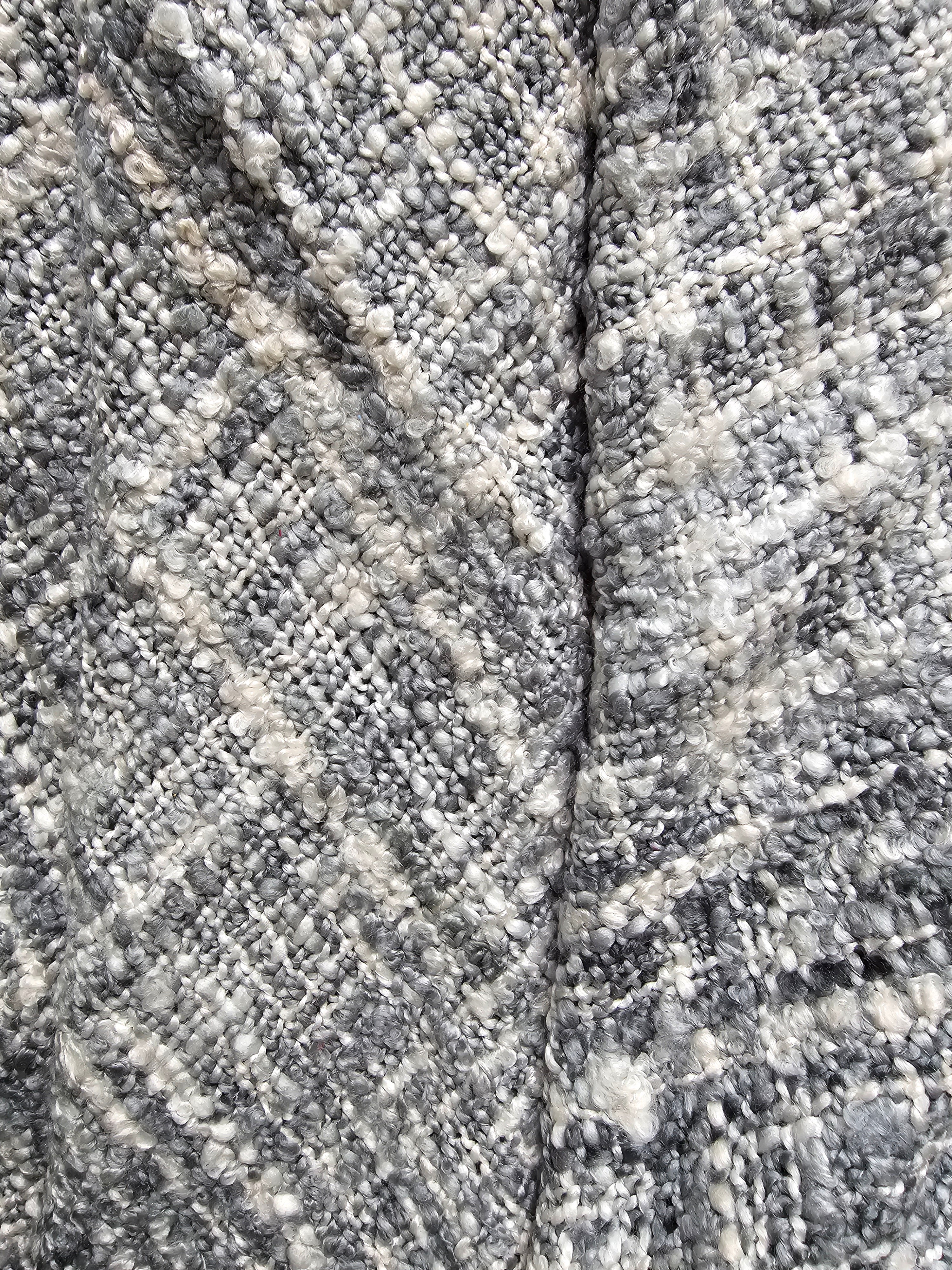 Close-up of textured stone surface with a crack running through it