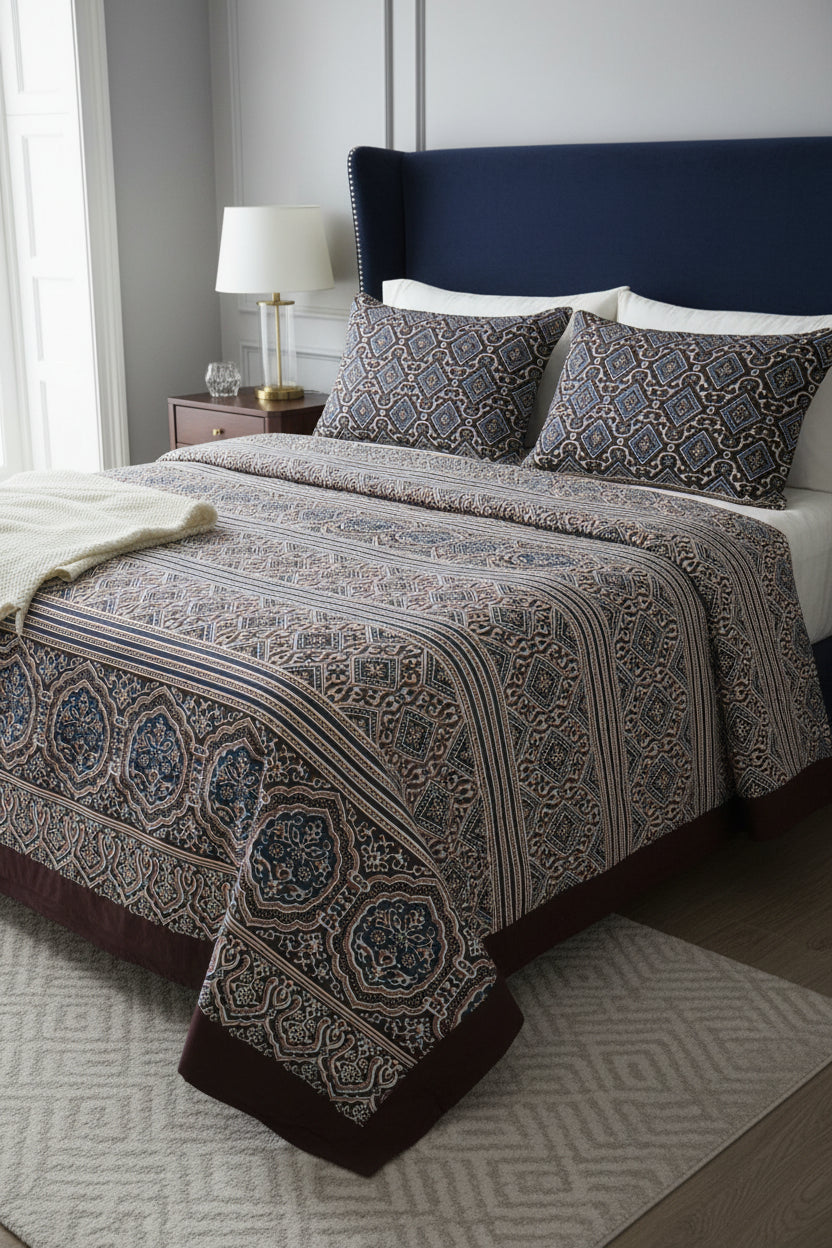Deep blue and brown cotton bed sheet featuring a traditional block-printed geometric pattern and ornate floral border details.