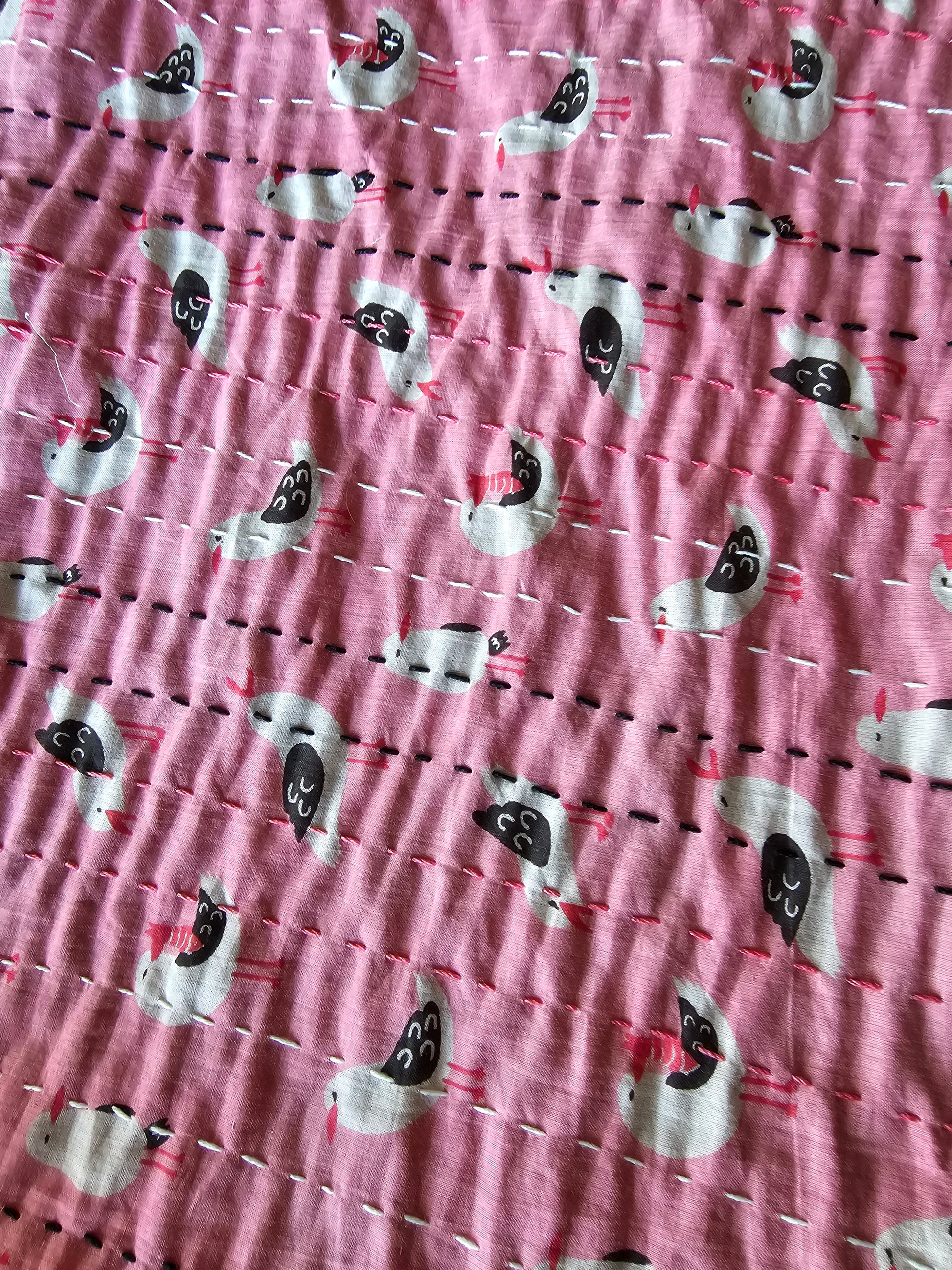Patterned fabric with small white shapes on a pink background