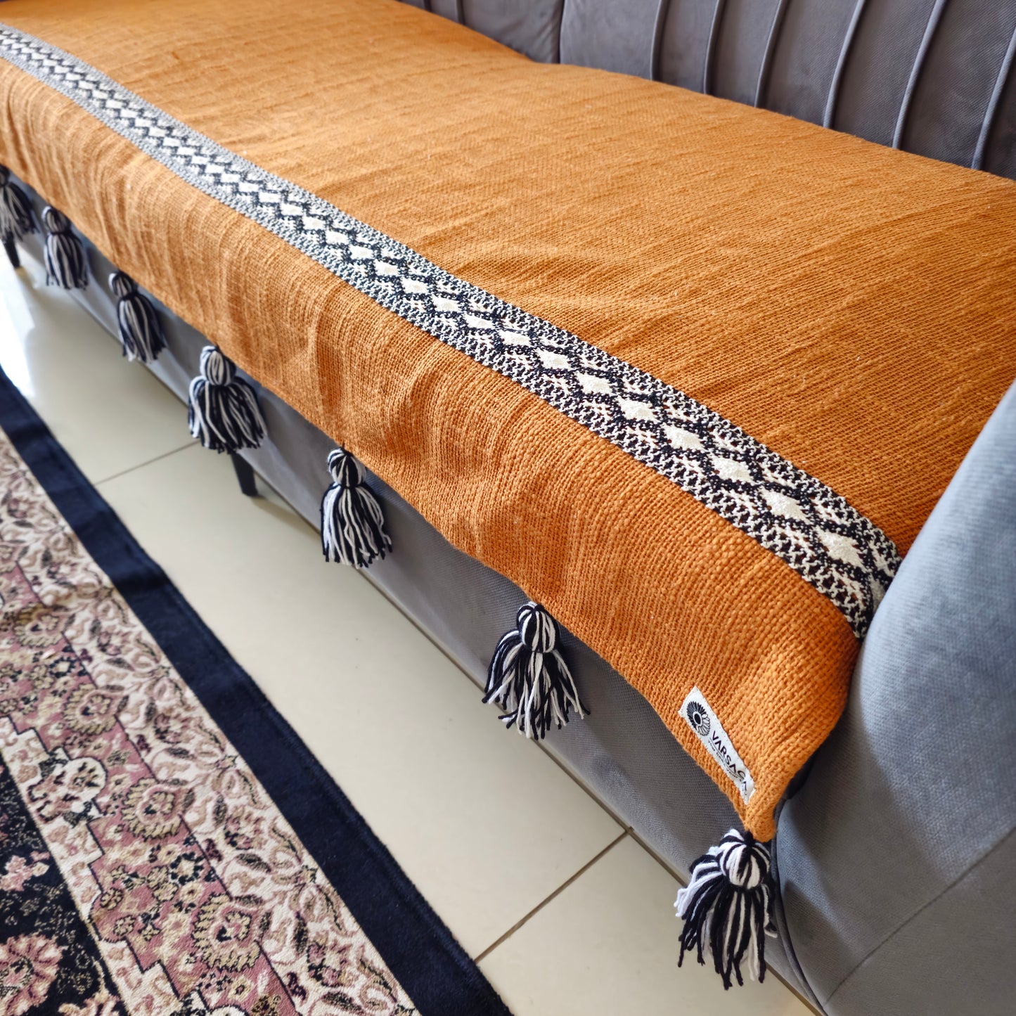 earthy orange sofa cover tassels