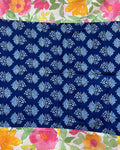 Cotton table cover featuring vibrant watercolor floral panels flanking a contrasting central band of traditional indigo blue block-printing.