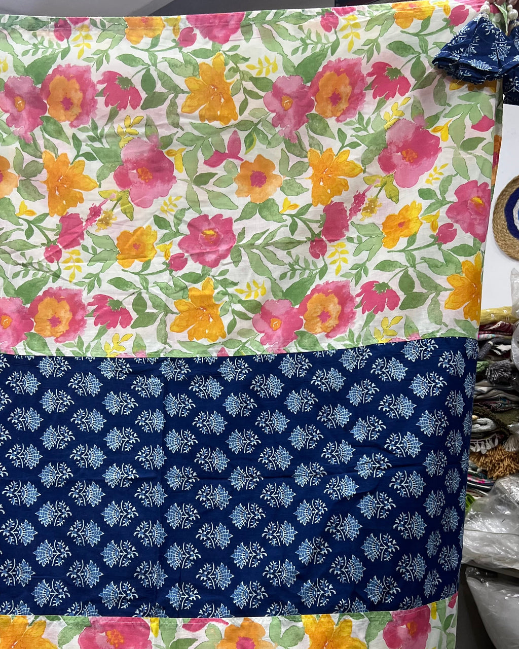 Cotton table cover featuring vibrant watercolor floral panels flanking a contrasting central band of traditional indigo blue block-printing.