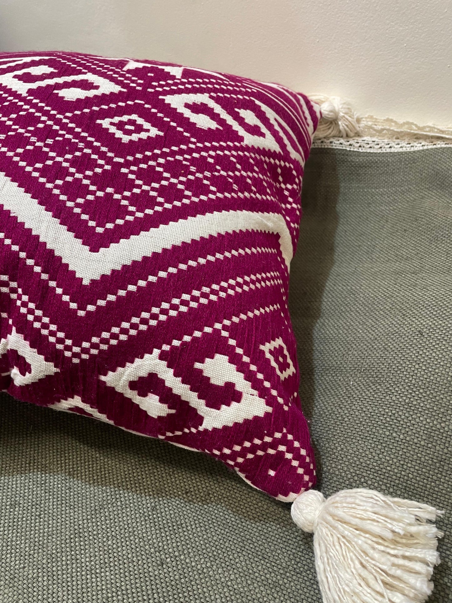 Decorative pillow with a purple and white pattern on a gray surface