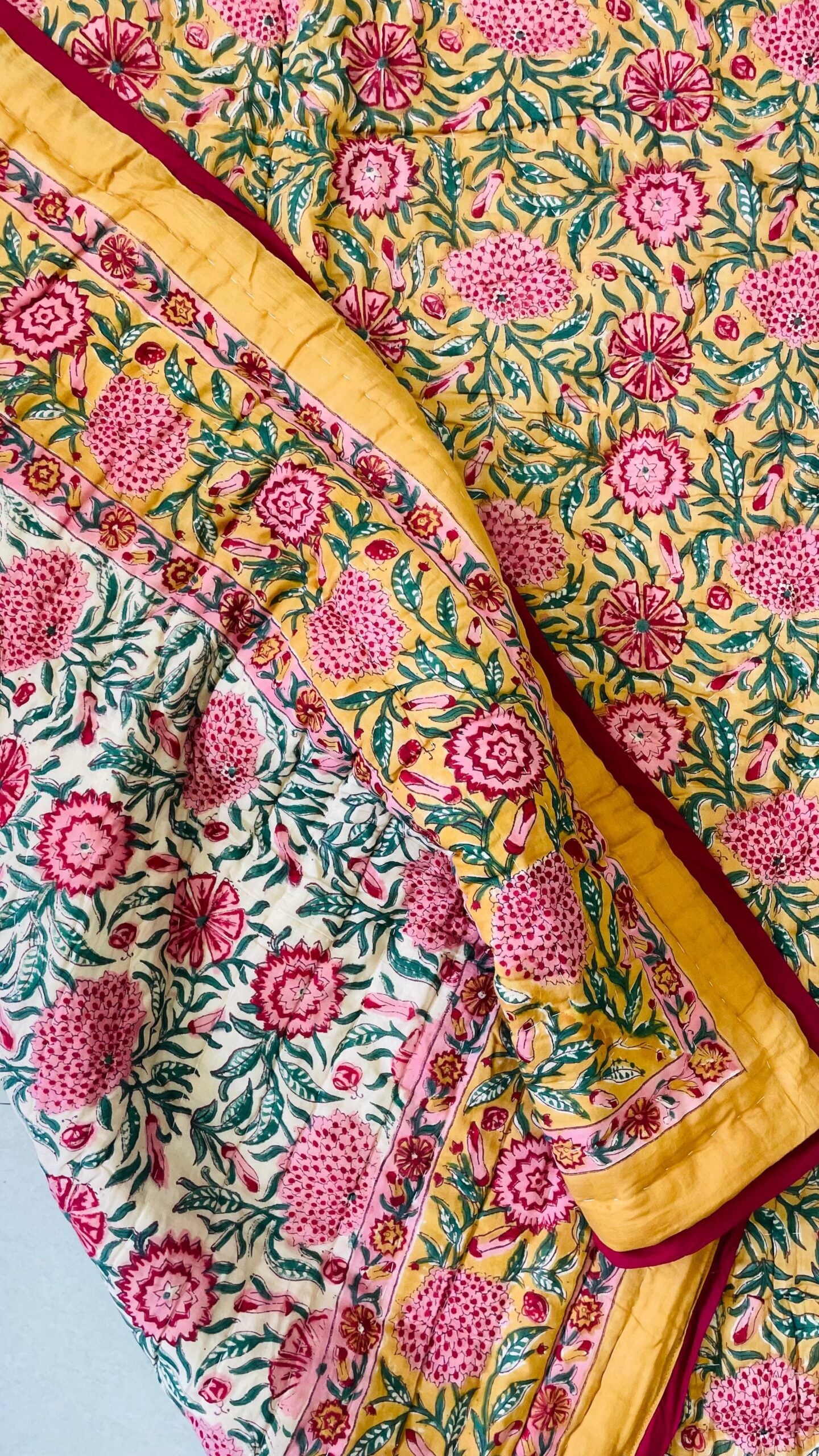 Floral patterned fabric with yellow border on a blue background