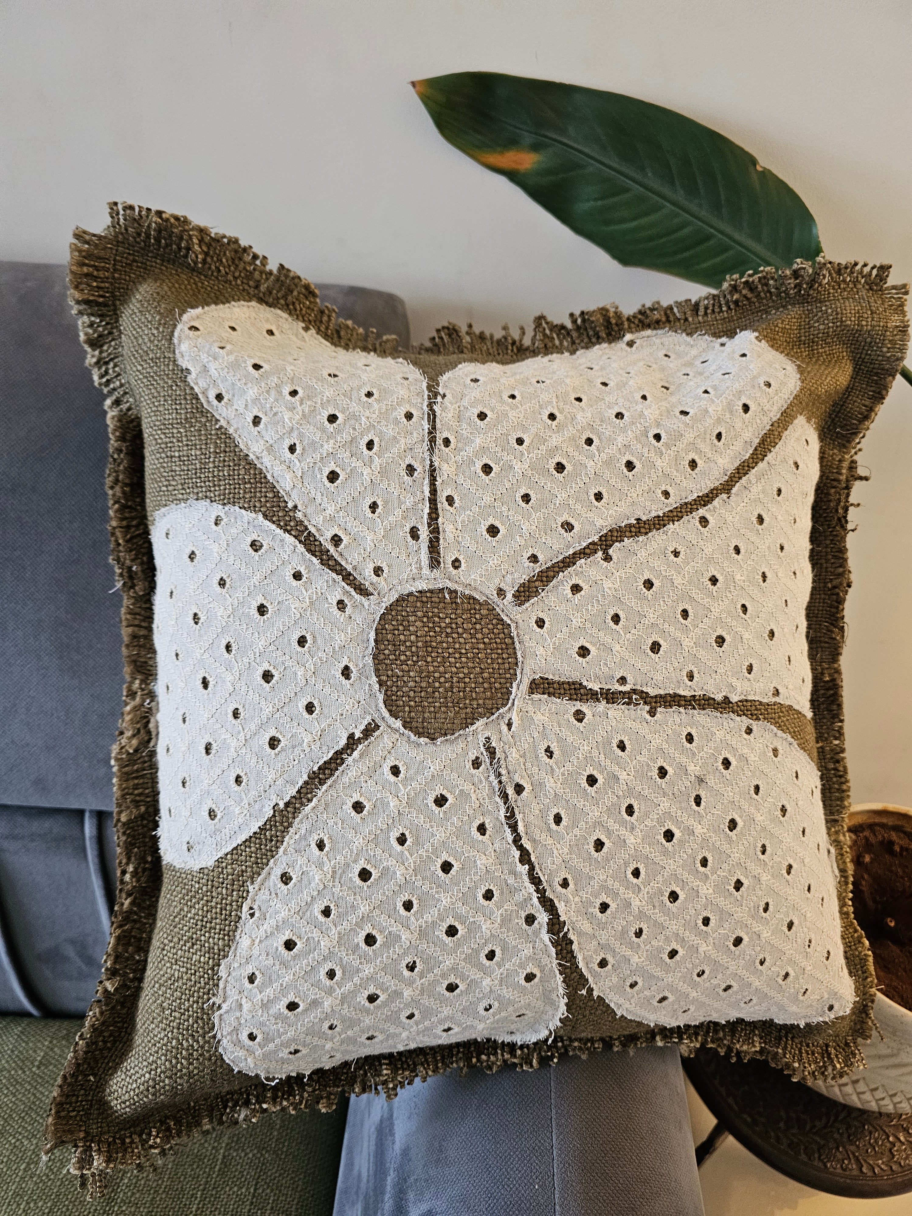 Decorative pillow with floral pattern on a chair