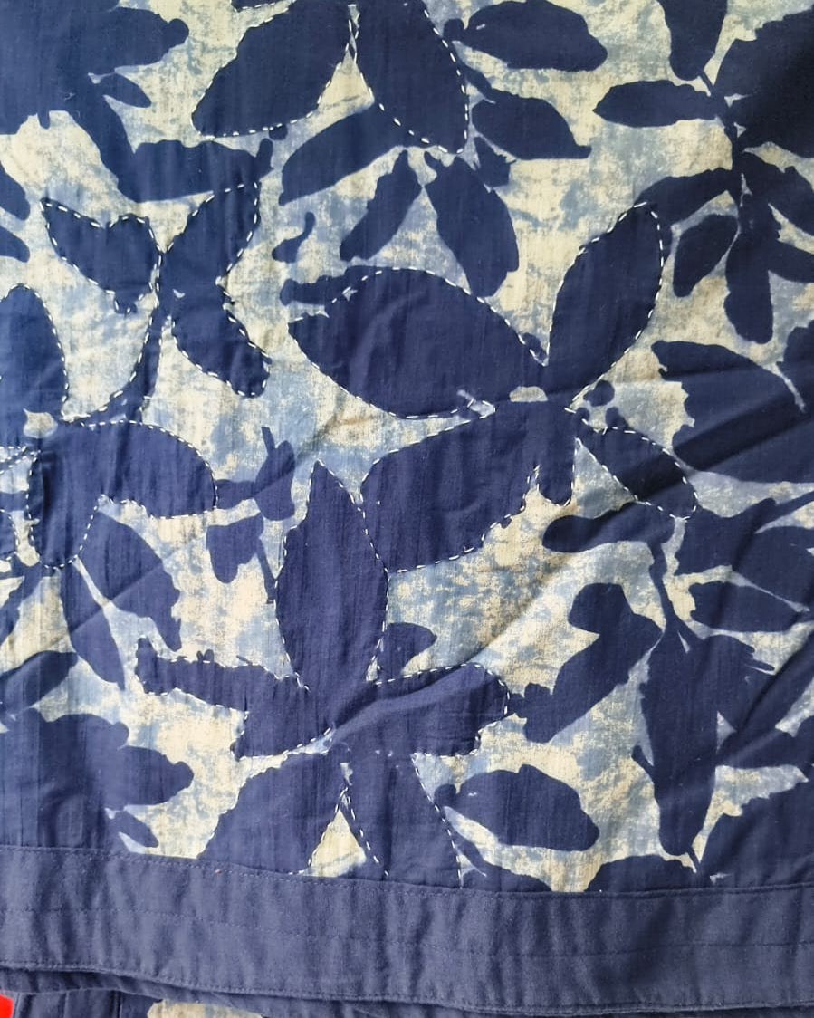 Indigo blue and off-white botanical block-print cotton single razai featuring traditional running Kantha hand-stitching (60x90 inches).