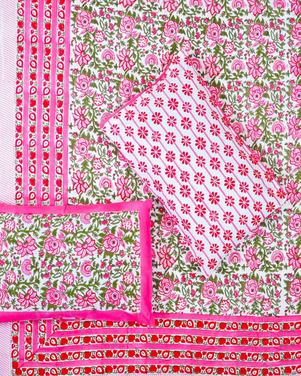 100x108 inch king size cotton bedsheet and matching pillow covers styled with a traditional magenta pink and green handblock floral rose print.