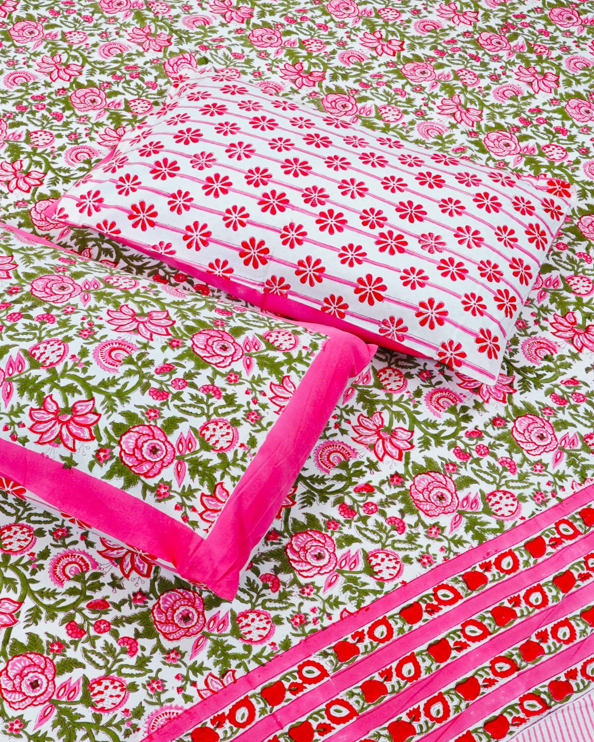 100x108 inch king size cotton bedsheet and matching pillow covers styled with a traditional magenta pink and green handblock floral rose print.