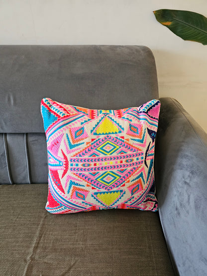 Colorful patterned pillow on a gray sofa