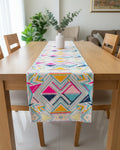 Multicolor geometric Jacquard cotton dining table runner featuring vibrant Aztec patterns in hot pink, mustard yellow, and turquoise, with Vasaca brand labels.