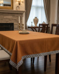 Solid mustard yellow handloom cotton table cover framed by a striking black and white geometric patterned border.