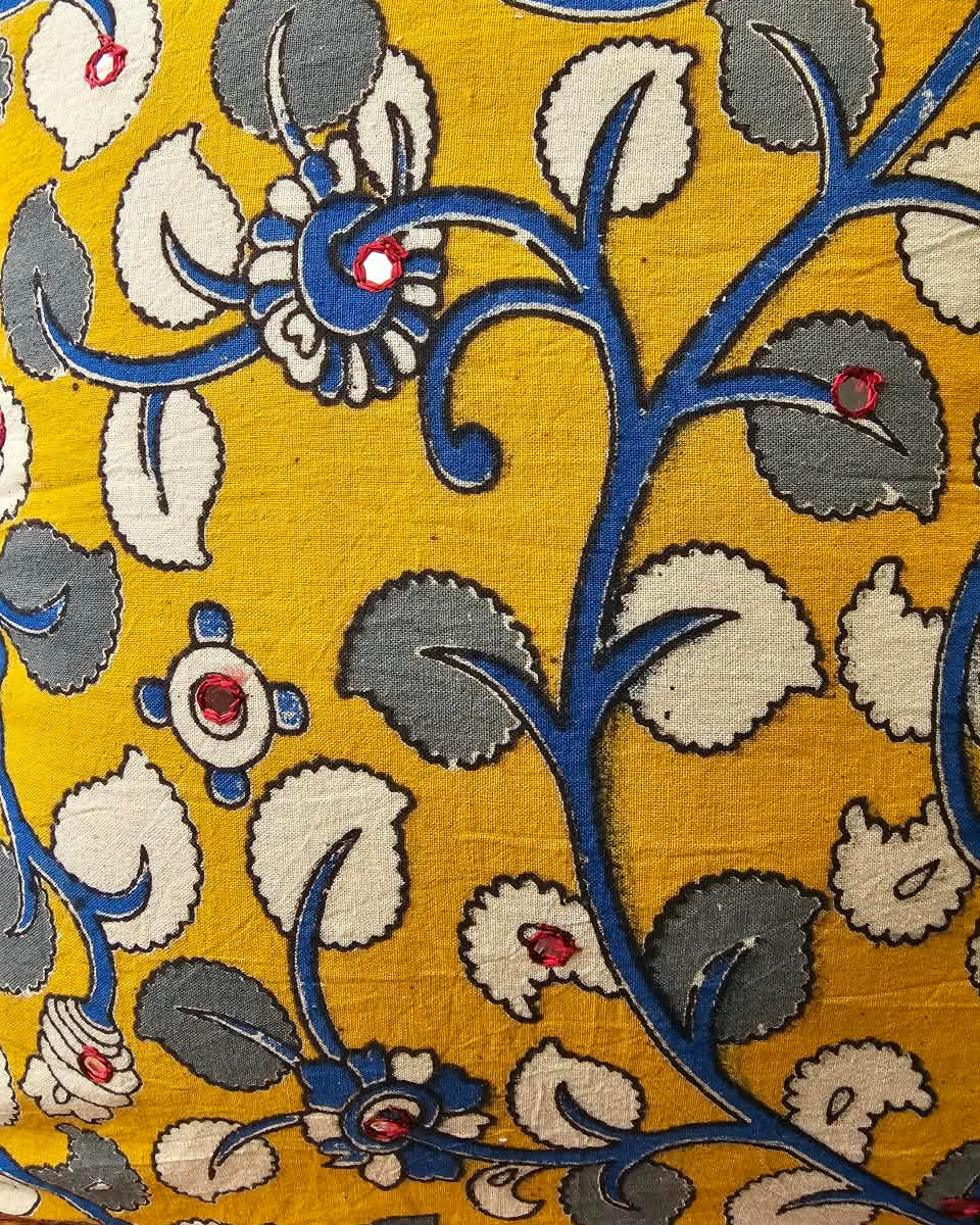 Mustard yellow cotton cushion cover featuring traditional blue and grey handblock floral vine prints with subtle accent embellishments.