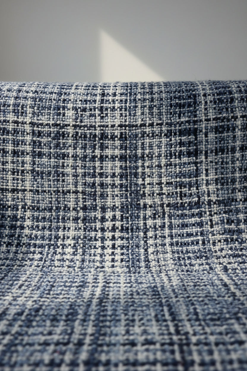 Navy and sky blue handwoven chunky woolen sofa throw blanket featuring a textured windowpane grid plaid pattern and twisted fringe tassels.