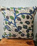 Natural off-white cotton cushion cover featuring traditional blue and green handblock floral vine prints with subtle accent embellishments.