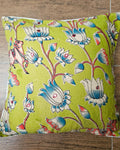 Olive lime green cotton cushion cover featuring traditional blue and white handblock lotus floral prints with subtle accent embellishments.