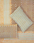 100x108 inch king size cotton bedsheet and matching pillow covers styled with a traditional orange and green floral bud handblock print.