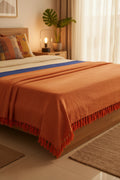 Orange fabric with frayed edge on a white background