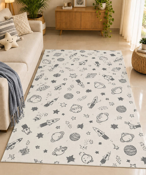 Off-white cotton area rug with charcoal outer space rocket and planet prints styled in a cozy kids nursery setting