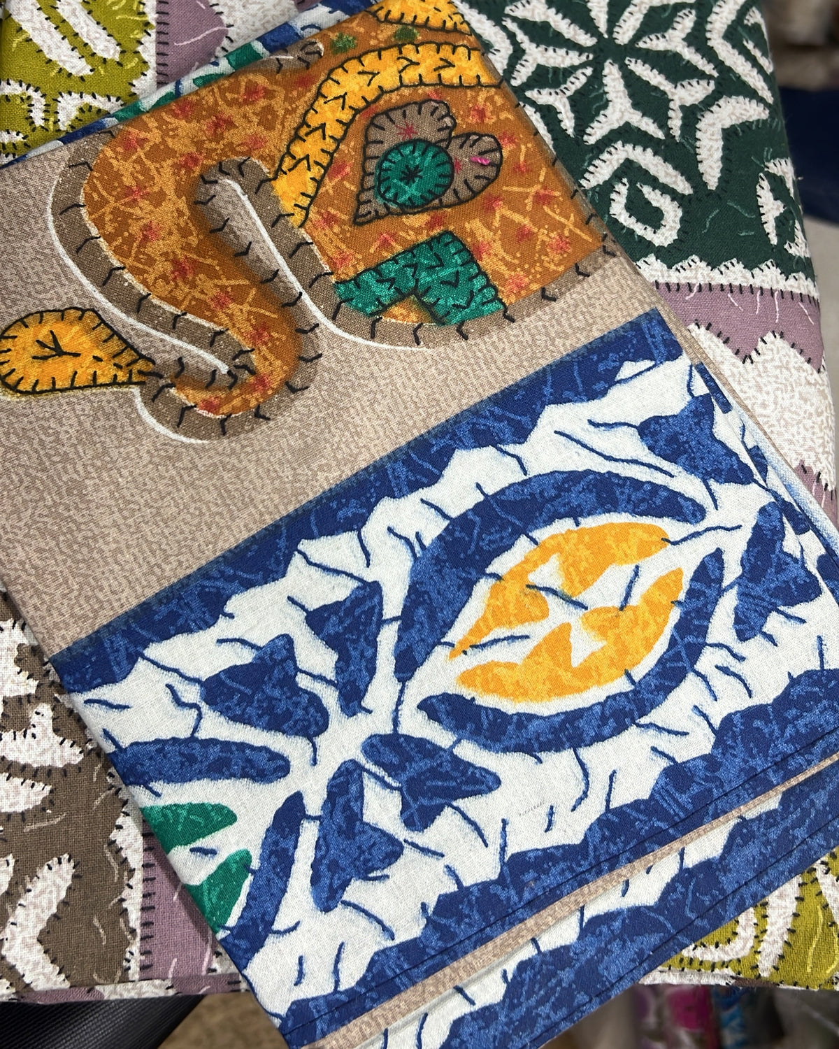 Artisanal patchwork kantha cotton bed sheet and pillow cover set featuring intricate multi-color block-printed panels and traditional hand-stitching.