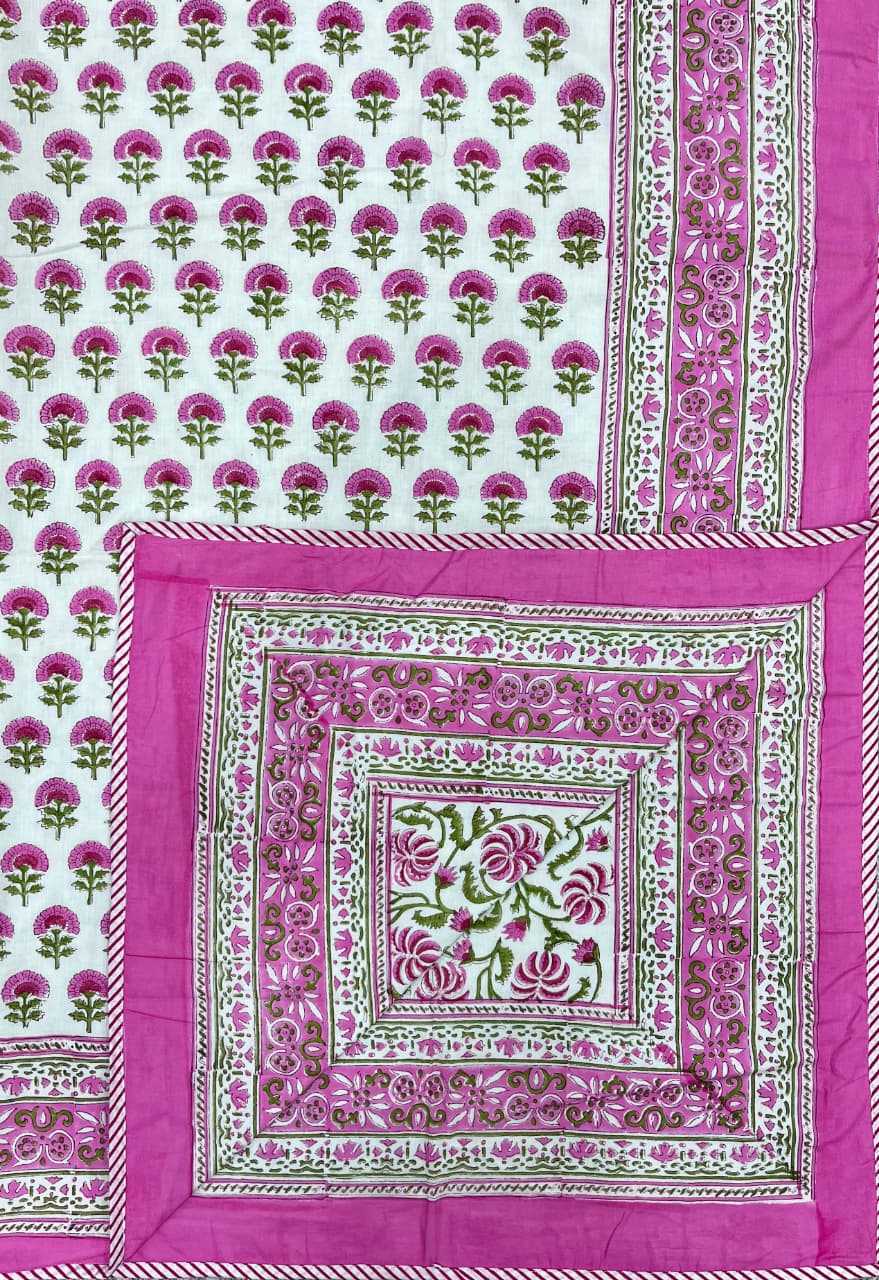 Decorative pink and green patterned fabric with a central square design.