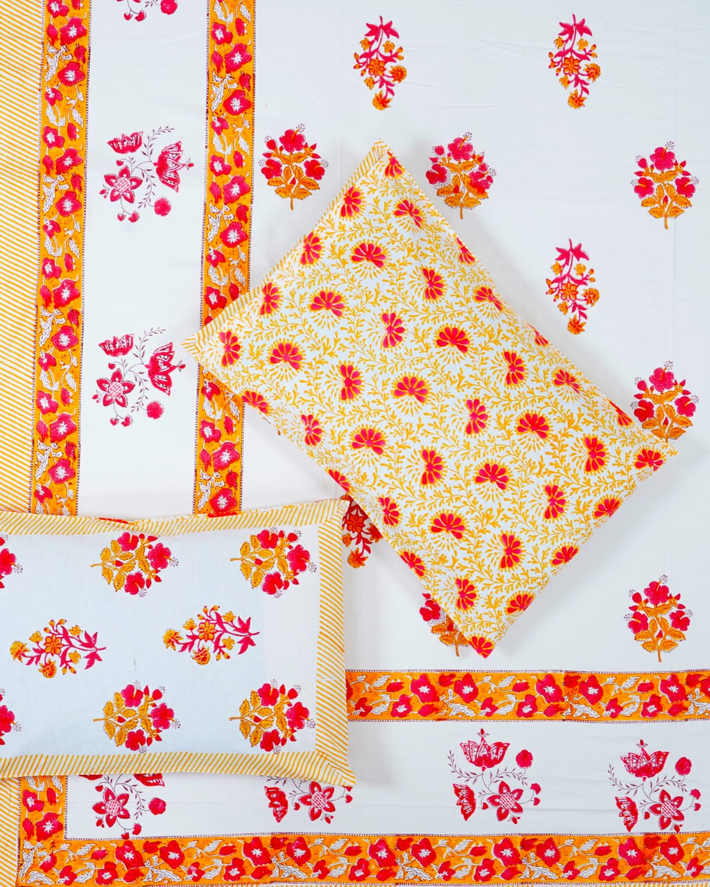 100x108 inch king size cotton bedsheet and matching pillow covers styled with a traditional pink and orange floral handblock print.